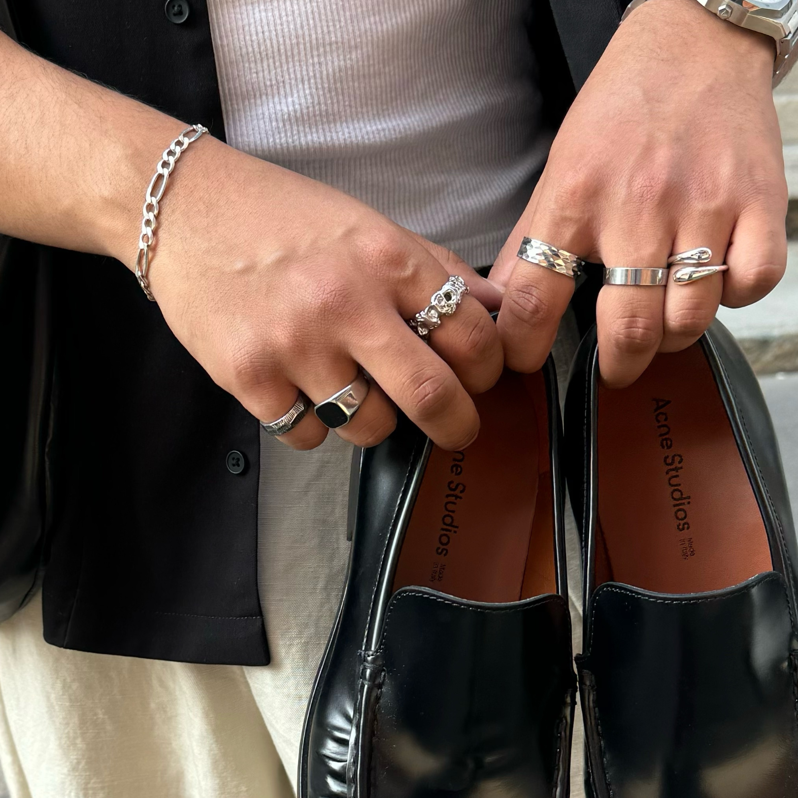 trending mens jewellery on hand, featuring silver signet ring, onyx rings and a hammered ring